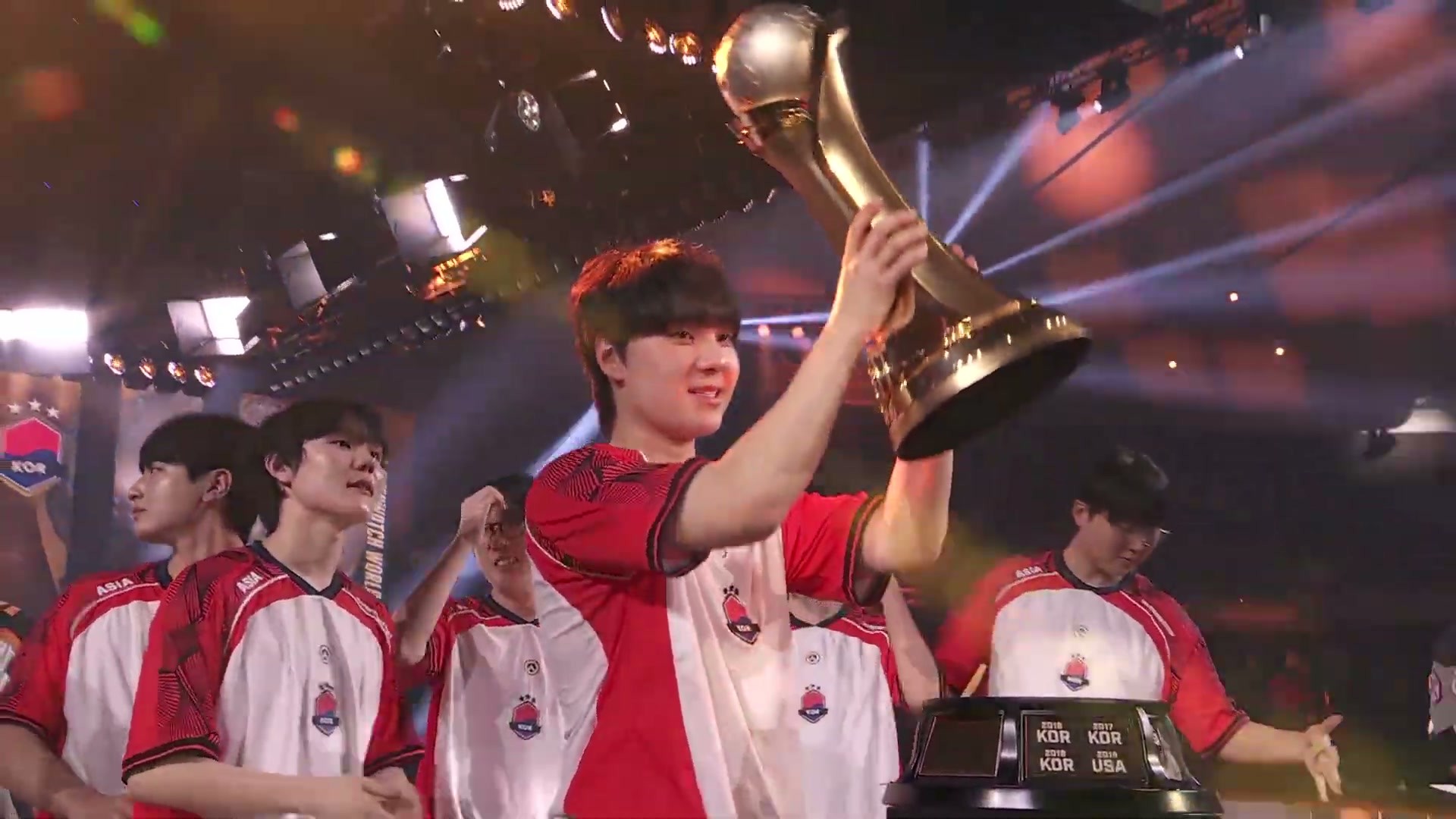 A South Korea player lifts the Overwatch World Cup trophy on stage at BlizzCon 2026
