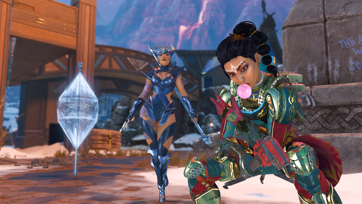 Apex Legends screenshot of three Legends posing with weapons under an aurora sky