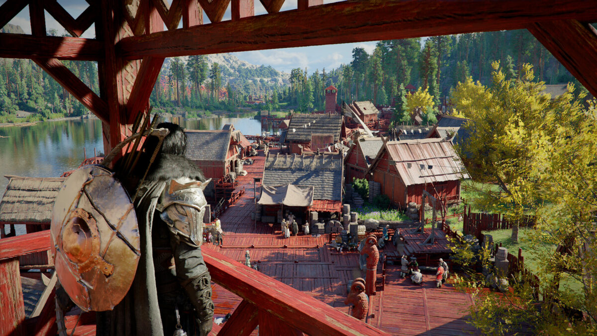 Kliff looking down from a red wooden gate over a bustling Greymane Camp beside a lake in Crimson Desert