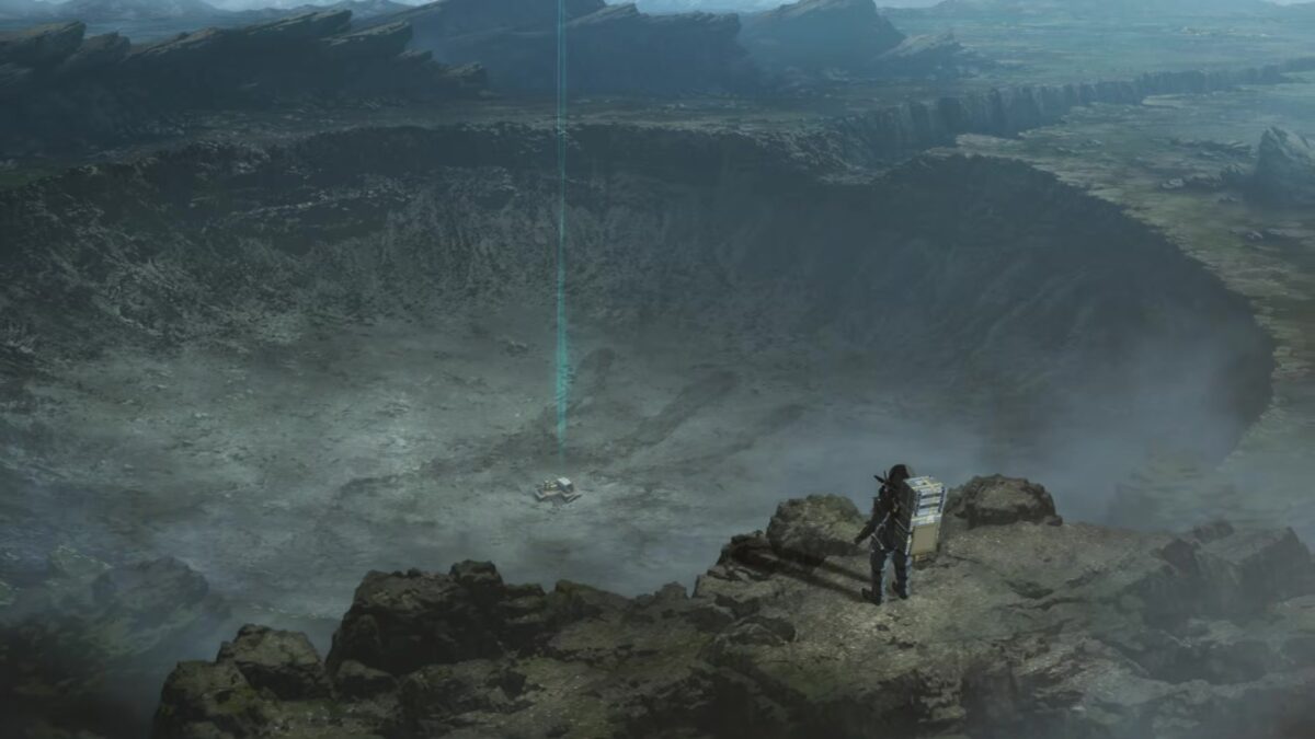 A porter with a cargo backpack stands on a rocky ridge above a vast crater in the Death Stranding Isolations teaser