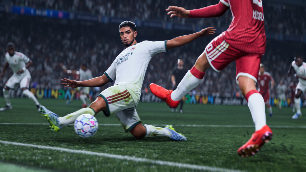 A Real Madrid player in EA Sports FC 27 sliding in to win the ball from a red-shirted attacker