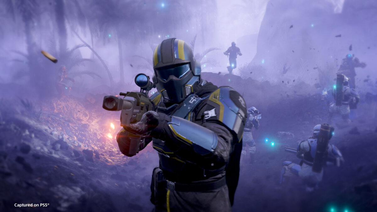 Helldivers 2 screenshot of a Helldiver in black and yellow armour firing an assault rifle in purple fog, from the official Steam page