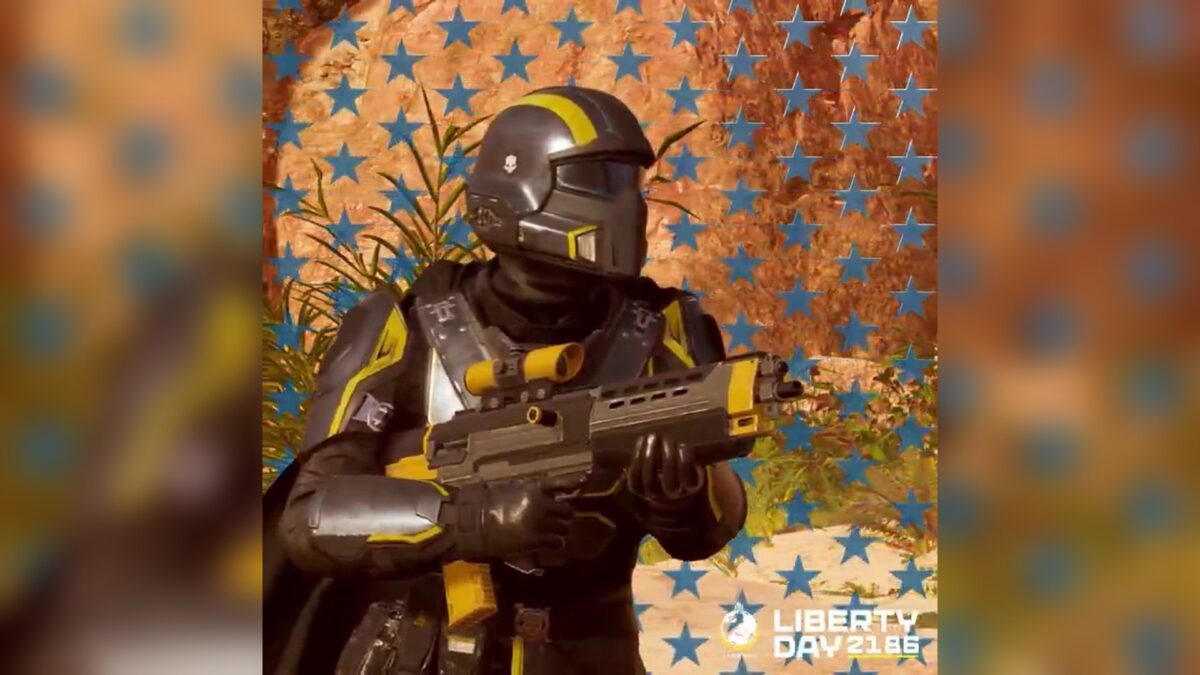 A Helldiver in black and yellow armor holds the AR-23L Liberator in front of a star-patterned wall, with the Liberty Day 2186 logo, from the official Helldivers 2 teaser