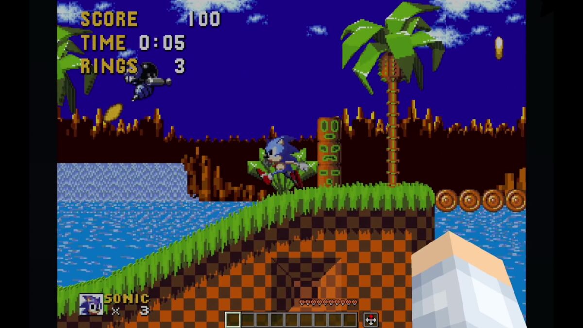 Sonic the Hedgehog's Green Hill Zone rendered in Minecraft blocks, with the Minecraft hotbar and first-person hand visible