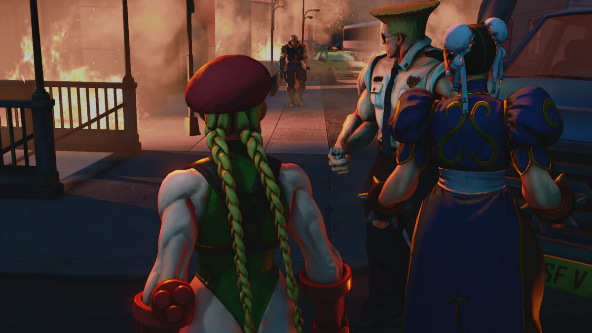 Cammy, Chun-Li and Guile stand together in a Street Fighter V story scene with a burning building behind them