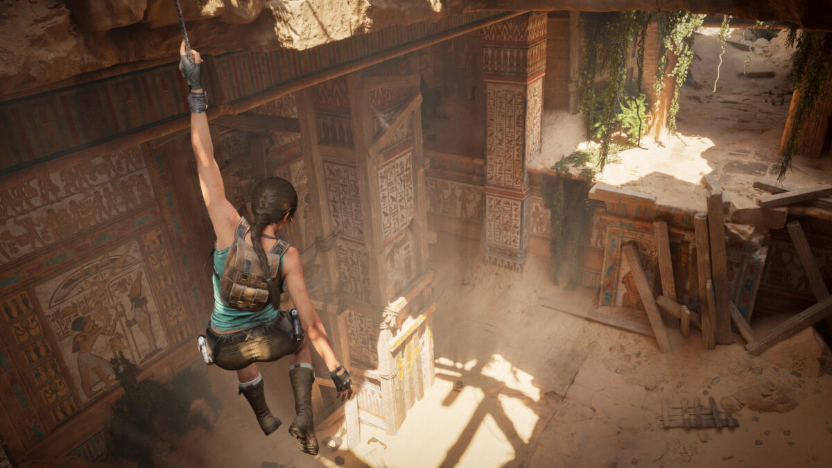 Lara Croft hanging from a rope above a sunlit Egyptian tomb in Tomb Raider: Legacy of Atlantis