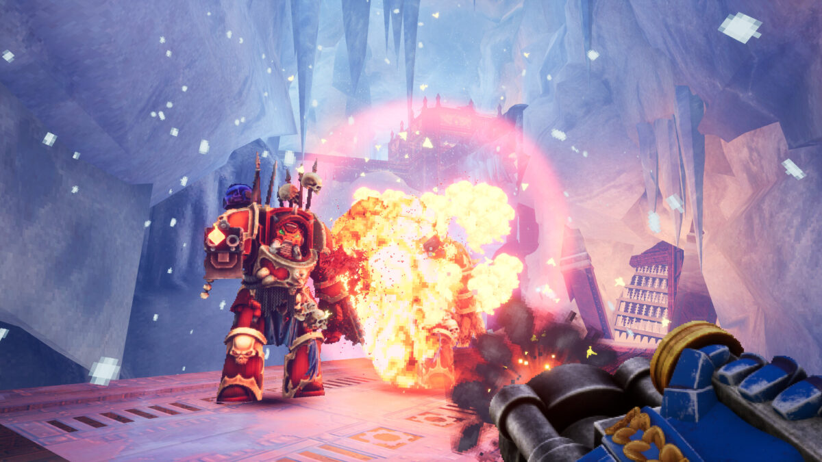 An Ultramarine fires a flamer at a burning enemy in a frozen cavern in Warhammer 40,000: Boltgun 2