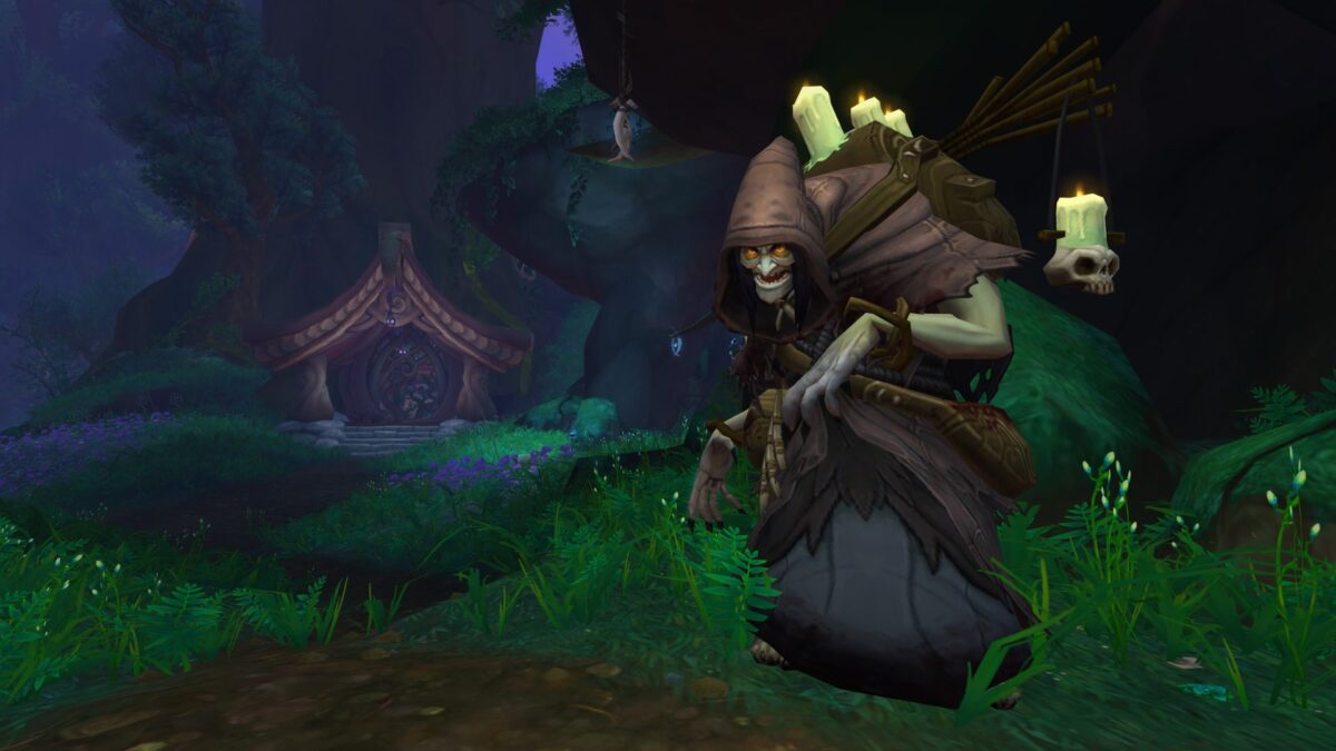 A hooded witch with candles strapped to her pack creeps through a dark forest toward a cottage in World of Warcraft's Talebound